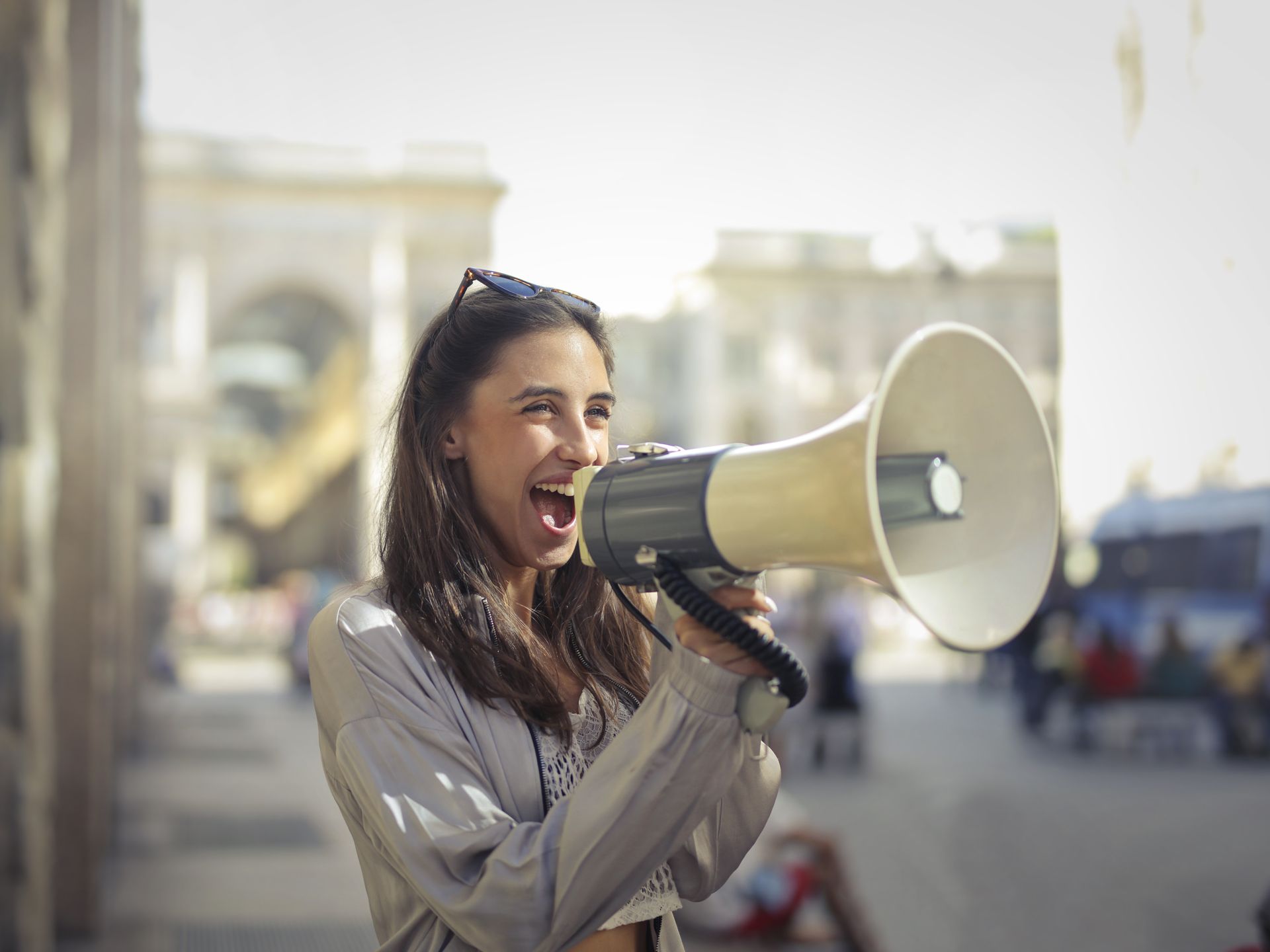 A woman shouting boldly into a megaphone